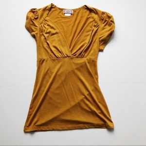 Mustard yellow tunic with sleeve detail.